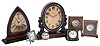 Clocks- 7 (Seven) Waltham 8 day time only: bronze library clock; mahogany library clock; two travel clocks, one in folding leather case; 3 metal-case desk clocks; early 20th century