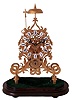 Reproduction skeleton clock, Chinese, brass framed chain fusee movement with white enamel Roman numerals on a wooden base with brass feet,