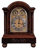 Germany, Westminster chime bracket clock, the walnut and burl walnut veneer case with molded, carved base, arched top, corinthian columns, and reeded ball feet, the sides with pierced wooden frets, composite dial with gilt spandrels, silvered chapter ring and chime control dials, with matted ground, blued steel hands, large 8 day, three train fusee movement, sounding the quarters on 4 gongs, and the hour on a larger gong