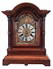 Germany, bracket clock, unsigned, 8 days, time and strike, spring driven movement in walnut arch topped case with 3/4 columns and brass dial with silvered chapter ring.