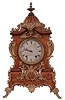 Lenzkirch Clock Co., Germany. 8 day time & strike mantel clock with dome topped wood case, fancy metal feet and applied metal decoration. Serial number 824081.