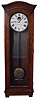 Standard Electric Time Co., Springfield, Mass., "Master Clock", time only, electrical driven movement in an oak case with a brass pendulum bob with concentric circles and painted metal dial