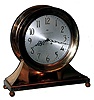 Chelsea Clock Co., Boston, Mass., Mass, a base and ball special "Commodore" ship's bell clock with ten inch dial {24.5cm}, in a red brass case with hinged bezel & button latch, retailed by E. P. Roberts & Sons, Pittsburgh as indicated on dial.