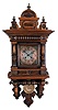Lenzkirch Clock Co., Germany, "Freischwinger" wall clock, 8 days, time and bim bam 1/4 strike, spring driven movement in an Alt Deutsch walnut case with pressed brass pendulum featuring female bust. The dial is brass with silvered engraved center and applied cast brass spandrels.