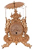 Novelty clock, possibly German, gilt brass case with Baroque ornament, thirty hour timepiece movement with two trains run from a single barrel, one for the flying ball pendulum, alternately caught and released by the two staff wielding putti beneath a parasol, the second train with recoil escapement and pendulum controlling the timekeeping