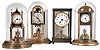 Clocks- 4 (Four) German "Anniversary" or 400-day clocks: Three are earlier with disk pendulums, including one by Becker and one by Anniversary. Three have round glass domes; One is the 4-glass crystal regulator style. The modern 4-ball model, with a John Wannamaker on the dial, has a functional moon phase indicator above the dial. 20th century