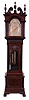 Walter H. Durfee, Providence, Rhode Island, 9 tube hall clock, 8 day, time, strike and quarter chimes, triple weight driven movement playing Westminster or Whittington chimes on tubes which are signed Walter Durfee with the patent date 1887. The brass dial signed Durfee has a silvered chapter ring with pierced brass spandrels and dial center, moon phase depicting sailing scene, strike / silent and tune selector dials. The case is mahogany and has carved cornice moldings, carved paw feet, carved broken arch top with flame finials and four full columns flanking hood, sunburst carving above trunk door flanked by four full columns and beveled glass in hood and trunk doors and raised panel on base. There are exceptional lion's head escutcheons on both hood and trunk doors.