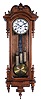 Germany, Vienna regulator wall clock, 8 day, time and Grand Sonnerie, three weight driven movement in an oak case with burled highlights and sides carved top and four spires topped by finials flanking door and three lower finials. The two part white enamel dial has Roman numerals.