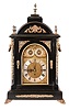Unsigned, England, large bracket clock, ebonized case with caryatid corners, cast ornaments and feet, the sides with cast, pierced fabric backed frets below foliate ornamented carrying handles, and the top with five finials, composite dial with silvered Roman numeral chapter ring, matted center, gilt spandrels, and the arch with silvered chime select and chime/ silent rings, large three train fusee movement, chiming Westminster on Eight Bells at the quarters, and counting the hours on a large gong