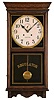 Clocks- 2 (Two) (1) Waterbury Clock Co., Waterbury, Conn., "Stork" wall hanging clock with a spring driven 30 day timepiece movement in an oak case. c1915. (2) William L. Gilbert Clock Co., Winsted, Conn., "No. 3035" wall hanging clock with a spring driven 8 day time and strike movement in an oak case. c1910.