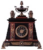 Feiver a Paris, France gilded brass architectural mantel clock, 8 days, time and bell strike, spring driven movement with silk thread suspension in a round case suspended above platform on four pad feet by four cast brass billars and surmounted by two doves. The white enamel dial is signed by maker.