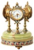 France, desk or table clock with weather station, the round, molded, green onyx base on ornamental gilt feet, and with wide, champleve enamel trim, and central champleve plaque, supporting three ornamental, turned columns surmounted by decorative cases with champleve enamel shields, one containing an 8 day timepiece with Arabic numeral white enamel dial and gilt, Louis XV hands, the second with centigrade and fahrenheit thermometers on a white enamel dial, and the last with barometer, also with white enamel dial