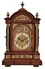 Winterhalder & Hofmeier, Germany, Westminster chime bracket clock, oak case with molded base and arched, molded top, with fluted columns, and applied foliate ornament, the composite dial with gilt spandrels, silvered chapter ring, chime and rate control dials, blued steel hands, 8 day, 3 train quarter chiming movement, sounding on 4 gongs at the quarters, and striking the hours on a larger gong, back plate signed