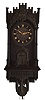 Trompeteruhren, or Trumpeter Clock, attributed to Emilian Wehrle, Germany, the ebonized, architectural case of Gothic design, with crenellated parapet, the front of which is adorned with applied rustic vine carving, the dial, doors, and base with various pierced, foil carvings, and with columns at the corners, case sides with pierced, arched access doors, Roman numeral wooden dial with blind, geometric, foil fret, pierced bone hands, three train, weight driven movement with wooden plates and brass wheels, and carved wooden pendulum, also with blind fret carving, music played on 6 pipes, the trumpeters emerging from behind the doors at the hour to play a tune