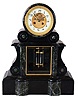 France, marble mantel clock, 8 days, time and strike, spring driven movement with visible Brocot escapement and compensated mercury pendulum in a black marble case with variegated green marble accents with brass dial and cream enamel chapter ring.