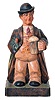 Karl Griesbaum, Germany, whistler, carved and painted figure of a man in hat and overcoat with umbrella tucked under his arm, enjoying a beer, his head moving from side to side and whistling a tune when activated by lever in his back, with "KG" logo on back and bottom