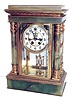 William L. Gilbert Clock Co., Winsted, Conn., Magdalene variant crystal regulator, green onyx case with gilt brass mounts, beveled glasses, Arabic numeral white enamel dial with sunk center, exposed escapement and beat adjustment, blued steel hands, 8 days, time and strike, movement with round plates, faux mercury pendulum.