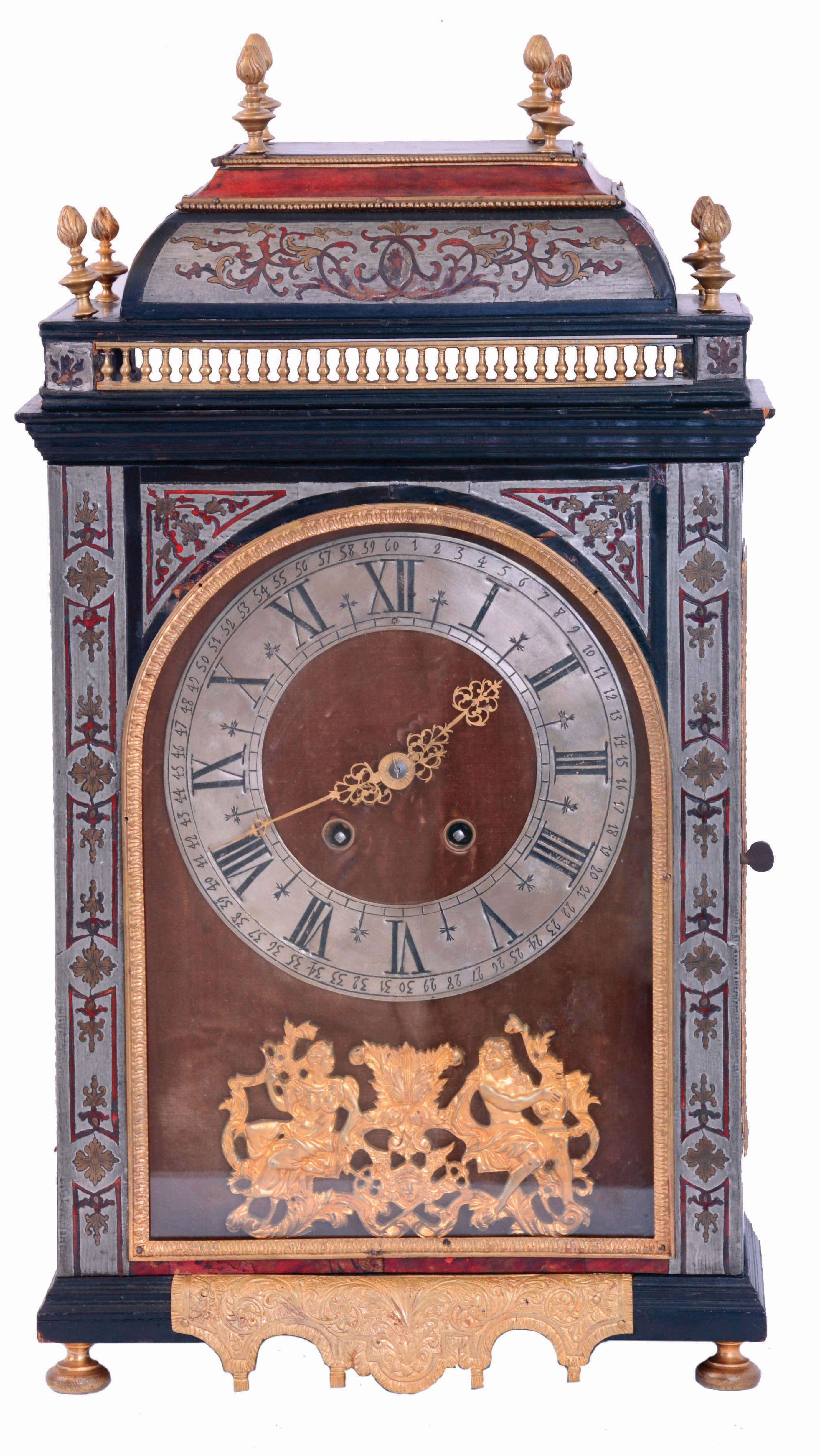 France, Pendule Religieuse, ebonized case with fine moldings and boulle work, the door with pewter fields inlaid with red tortoise shell and engraved brass, glazed case sides with tortoise panels and brass stringing, removable caddy top with inlaid pewter, gilt balustrade, applied bead moldings, and eight flame finials, maroon velvet covered dial with Roman numeral pewter chapter ring, and with cast ornament featuring two seated, classical figures, pierced and engraved brass hands, 8 days time and strike movement, mid 19th century, case with earlier components — Antique Clocks Price Guide