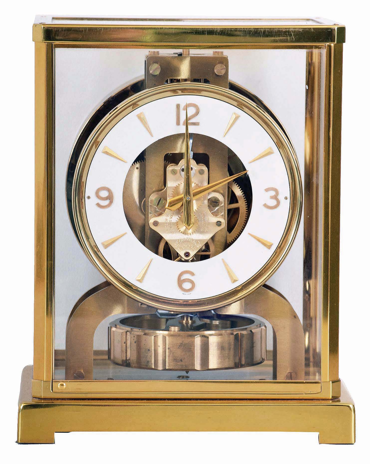 LeCoulture "Atmos" gilt brass and glass perpetual mantel clock, serial number 98063, front door hinges from side, in original green felt carrying box — Antique Clocks Price Guide