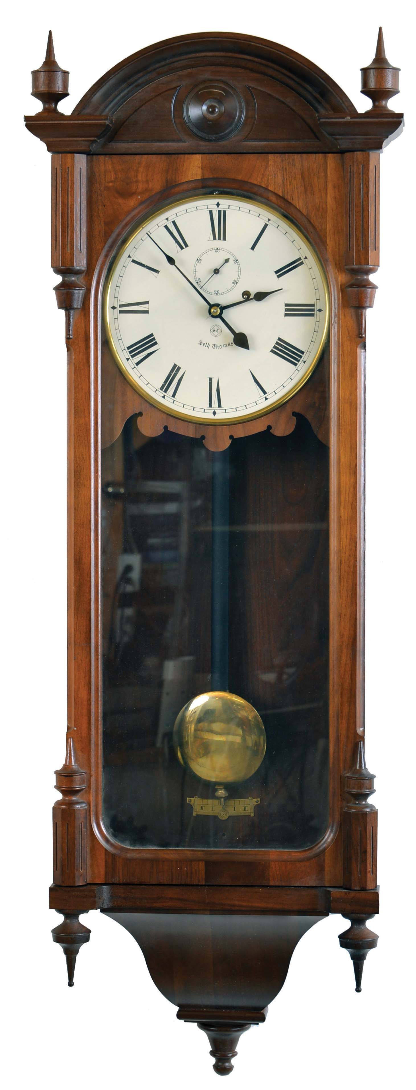 Seth Thomas Clock Co., Thomaston, Conn., "Regulator No. 6-Reissue" wall hanging clock with a weight driven 8 day timepiece movement in a walnut case.. The Regulator No. 6 was reissued by the Seth Thomas Clock Co in 1975. This particular one no longer has the label that indicates the serial number within the span of reissues. — Antique Clocks Price Guide