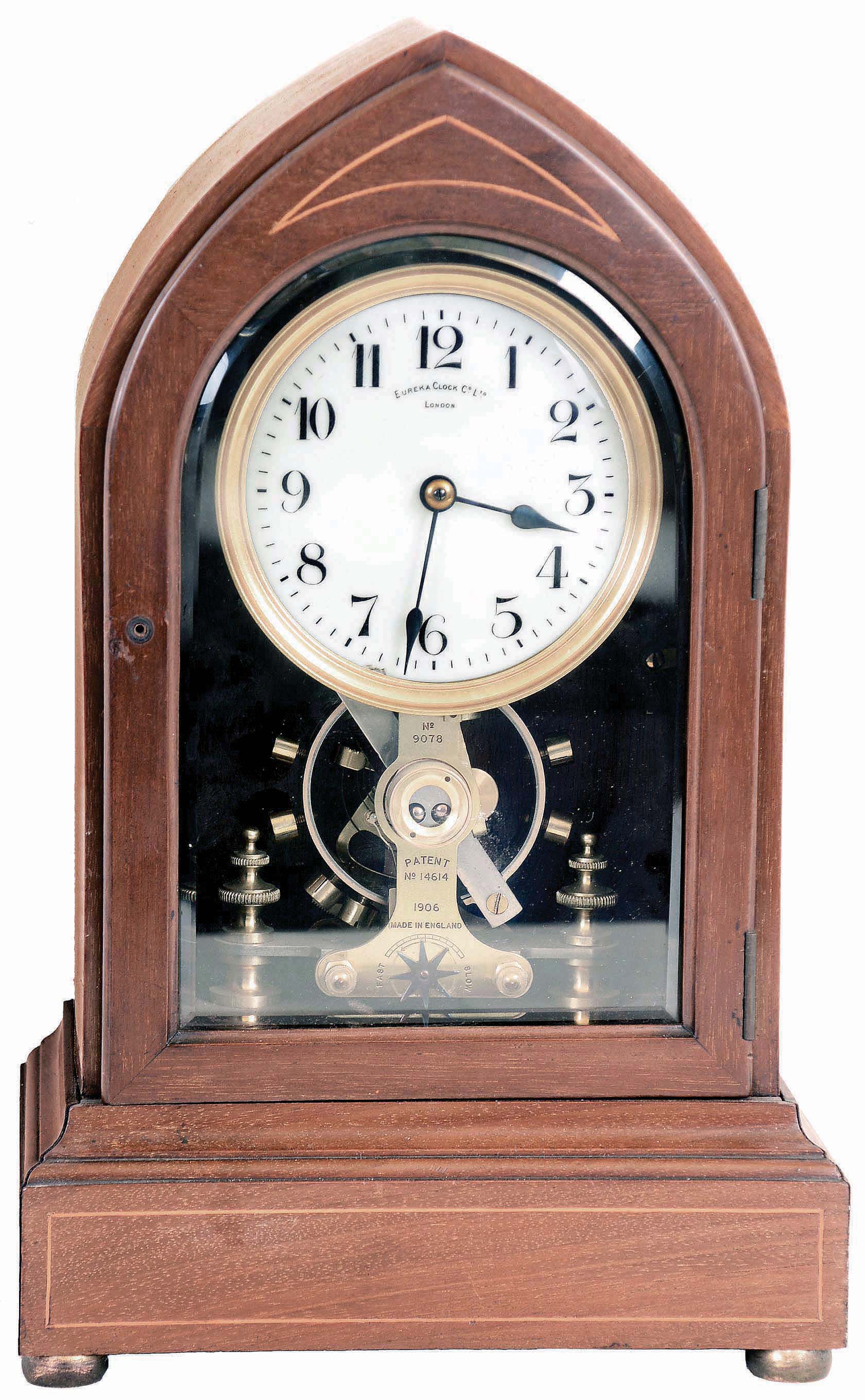 Eureka Clock Co. Ltd., London, England, battery powered mantel clock with oversized balance wheel movement in an inlayed Lancet or Beehive- style mahogany case with beveled glasses and cream porcelain dial, s#9078 — Antique Clocks Price Guide