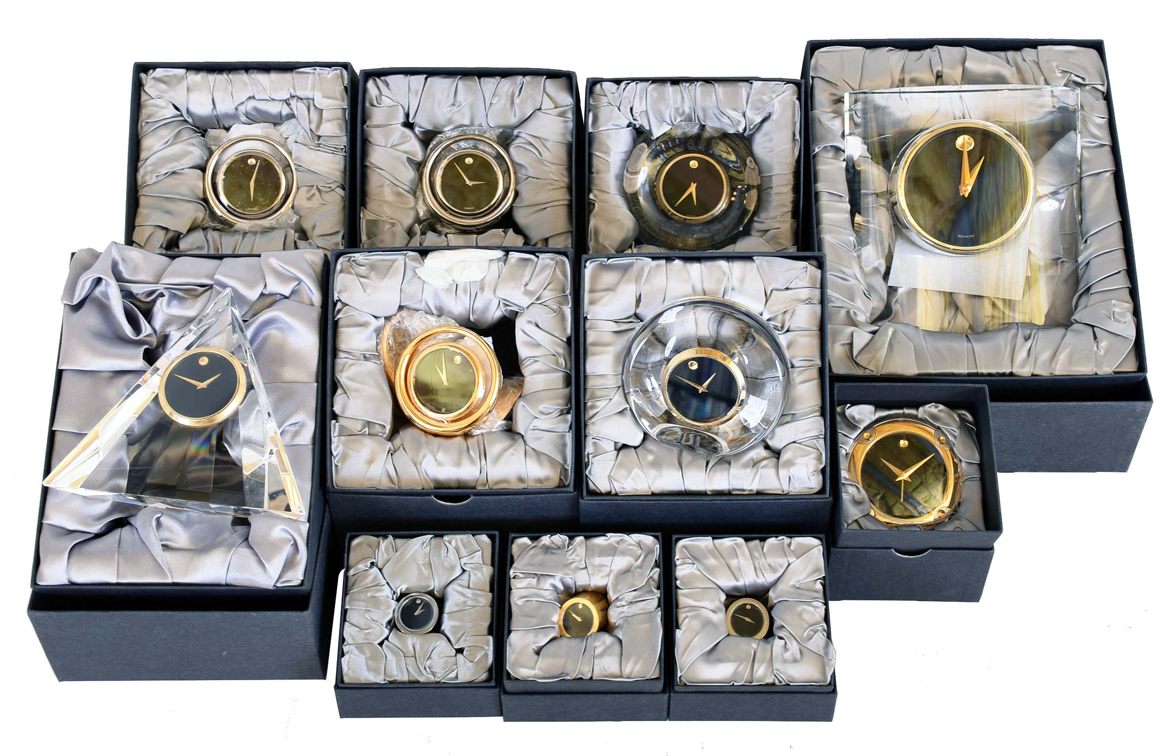 Clocks- 17 (Seventeen) Movado desk clocks, Japanese quartz movements, various models with brass, Lucite, etc., new / old stock in original gift boxes — Antique Clocks Price Guide