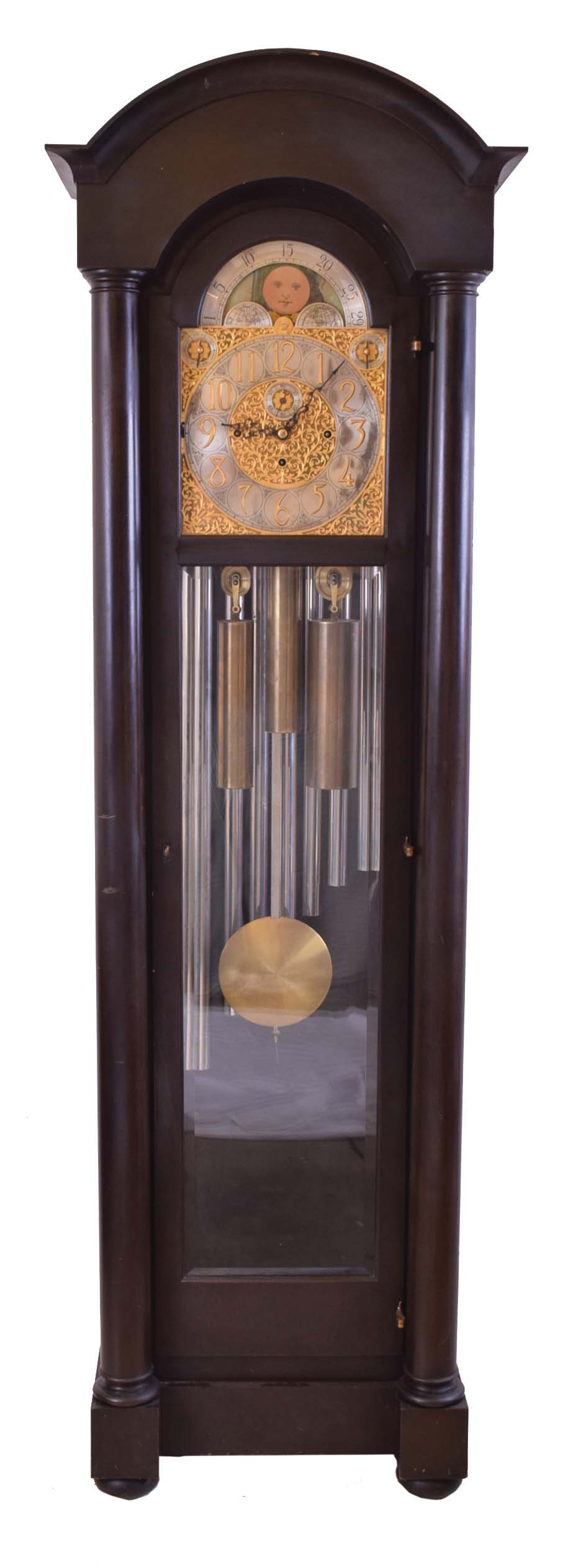 Herschede Hall Clock Co., Cincinnati, Ohio, "Pattern No. 86" hall clock, 8 day, time, strike and chime on 9 tubular bells, three brass weight driven movement in a mahogany case with full columns, beveled glass door and sides, arch top and resting on bun feet. The silvered brass dial has moon phase, spandrels, tune selector for Westminster or Whittington serial #7272 — Antique Clocks Price Guide