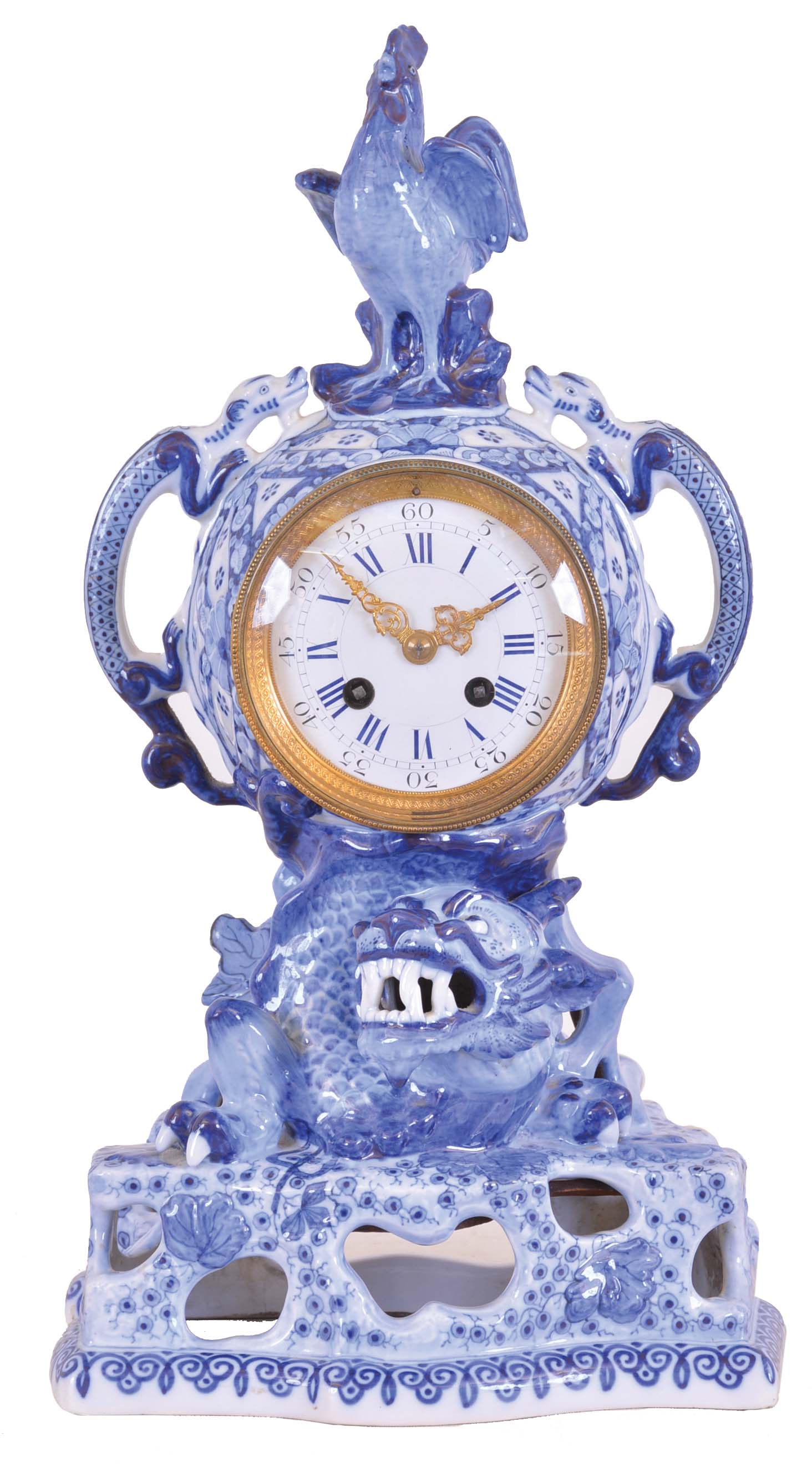 France, earthenware mantel clock, the openwork base with emerging dragon, case sides with giant salamanders, and surmounted by a crowing cock, decorated with blue transfer and free hand ornament in imitation of Canton porcelain, Roman numeral white enamel dial, gilt Louis XV style hands, and 8 day time and strike pendule de Paris movement — Antique Clocks Price Guide