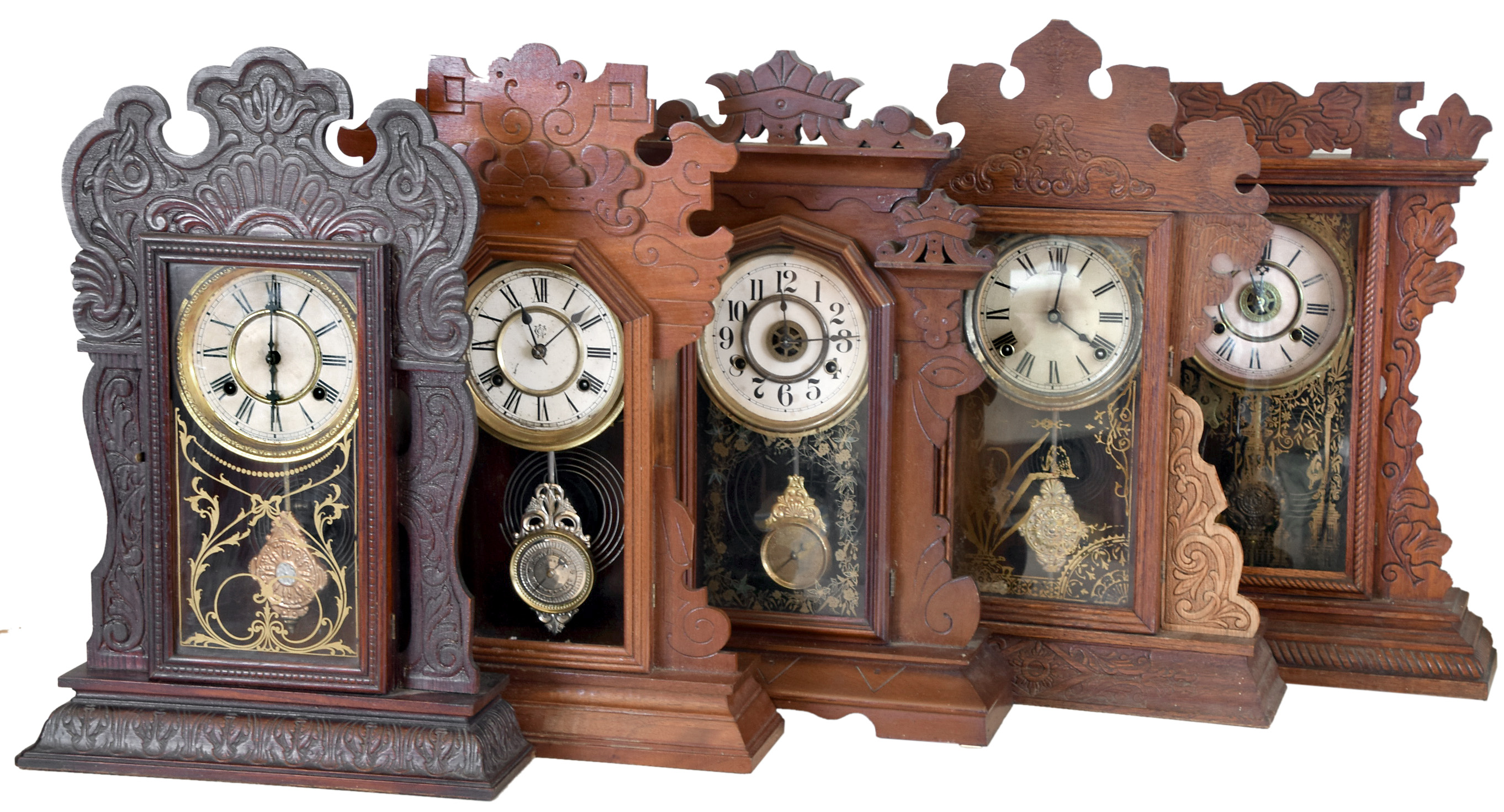 Clocks- 5 (Five): (1) Sessions Clock Co., Forestville, Conn. Kitchen style shelf clock with a spring driven 8 day time and strike movement in an oak case, c1900. (2) New Haven Clock Co., New Haven, Conn. "American Wringer Co Eclipse" shelf clock with a spring driven 8 day time and strike movement in an oak case, c1890. (3) Waterbury Clock Co., Waterbury, Conn., "Norwalk" shelf clock with an 8 day spring driven time and strike movement in a walnut case, c1890. (4) Waterbury Clock Co., Waterbury, Conn., "Idaho" shelf clock with an 8 day spring driven time and strike movement in an oak case, c1900. (5) Unidentified shelf clock with an 8 day spring driven time, strike and alarm movement in a walnut case, c1900. — Antique Clocks Price Guide