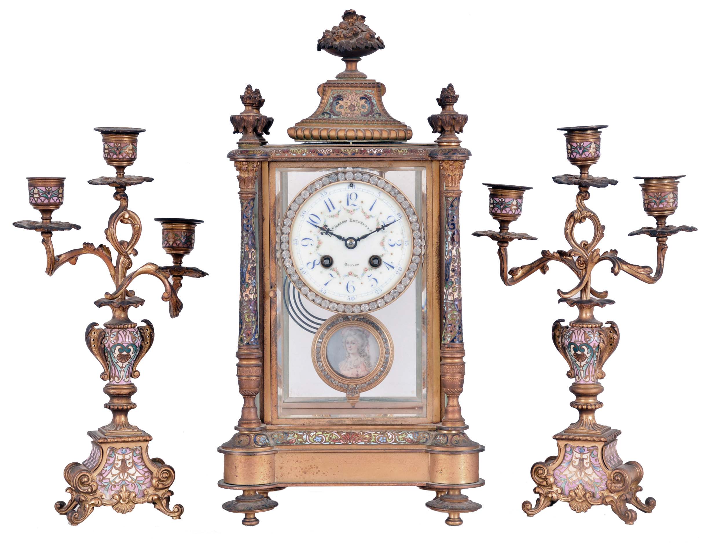 France, for Bigelow, Kennard, &amp; Co., 3 piece mantel garniture, ornate gilt and champleve enamel crystal regulator, Arabic numeral numeral enamel dial with floral garlands, blued steel hands, and brilliant set bezel, 8 day time and strike pendule de Paris movement, gilt, brilliant set pendulum with signed portrait of a young woman, the side pieces each holding three candles, and with gilt and champleve enamel ornamented surfaces — Antique Clocks Price Guide