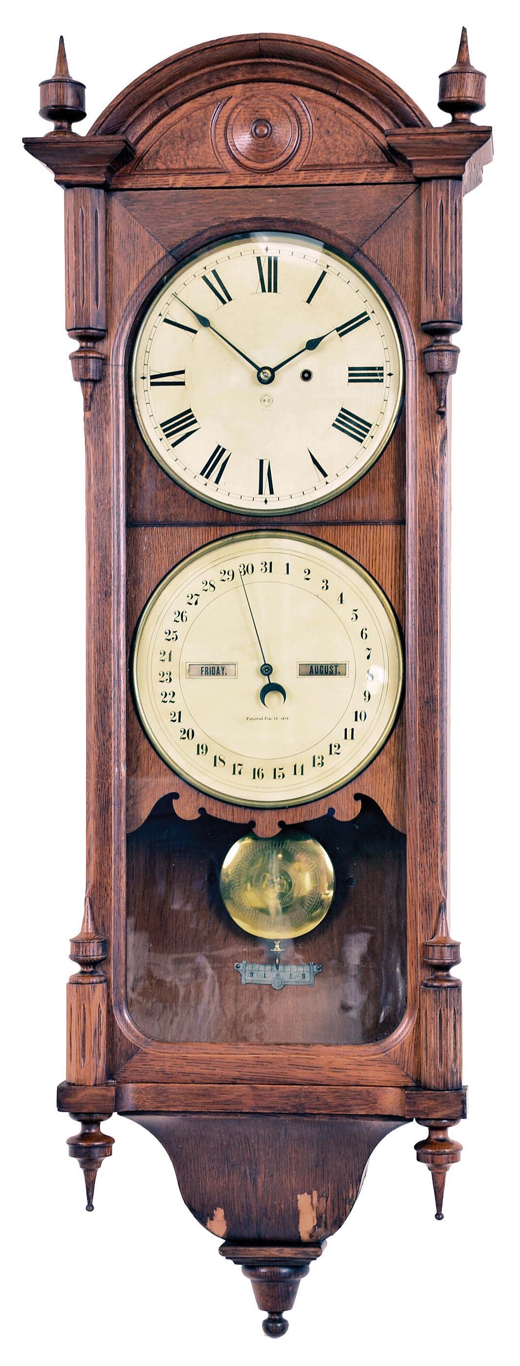 Seth Thomas Clock Co., Thomaston, Conn., "Office Calendar No. 10" wall hanging clock with a weight driven timepiece movement and an R. T. Andrews 1876 patent perpetual calendar in an oak case — Antique Clocks Price Guide