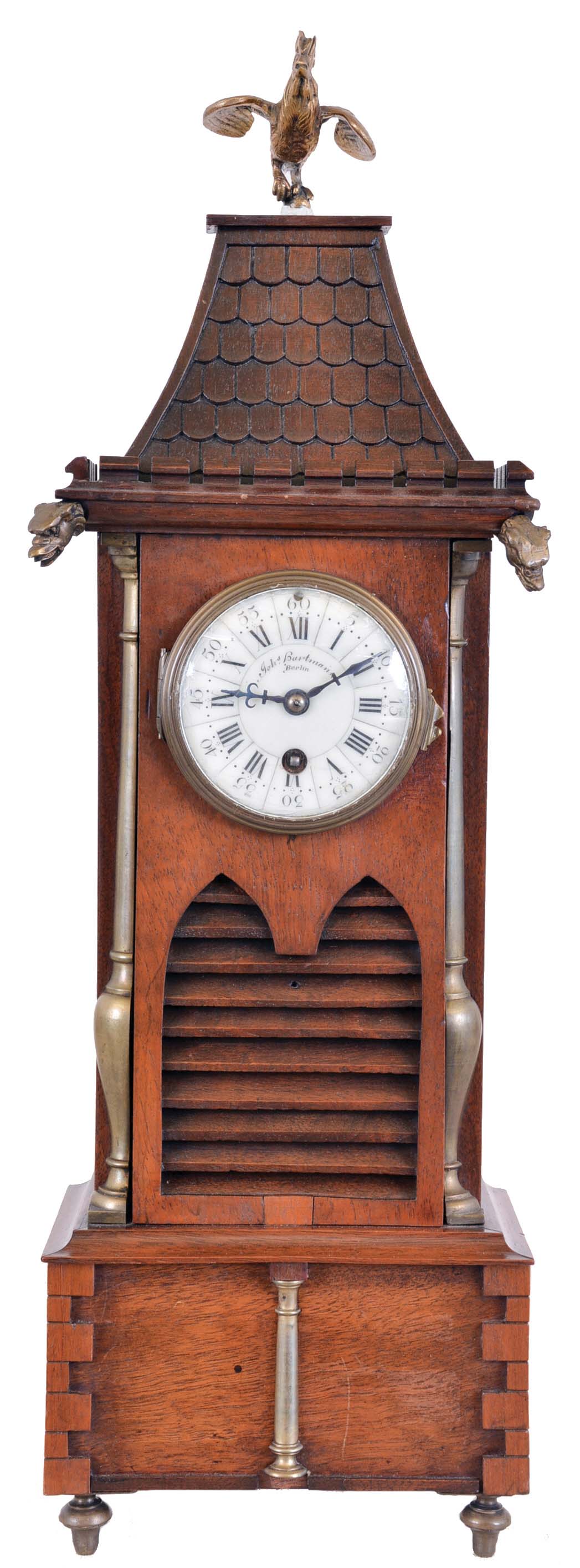 France, for Johs. Hartmann, Berlin, architectural shelf clock in walnut, the base with quoined corners, mid section with louvered lancet arches below the quoined mansard roof with crenellated cornice, gargoyle heads, and crowing cock finial, Roman numeral white enamel dial, blued steel hands, 8 day timepiece movement marked "Z. &amp; Co. Paris" — Antique Clocks Price Guide