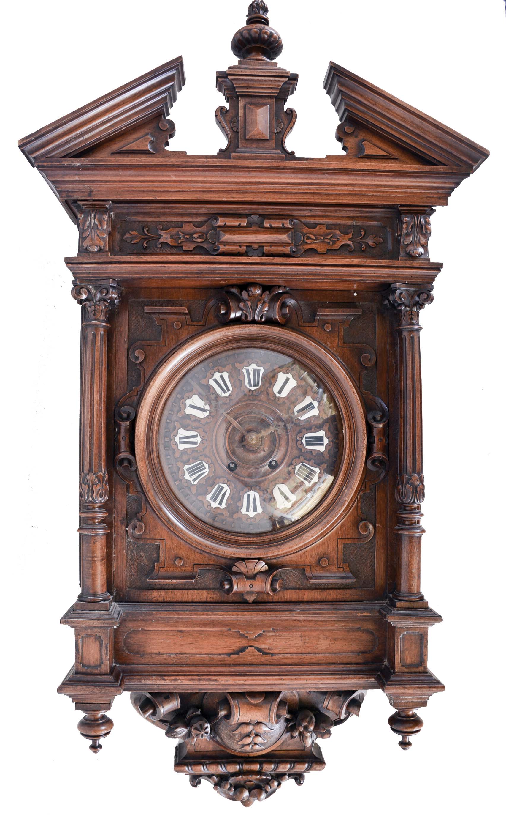 France, a large architectural wall clock, walnut case with nicely carved and turned ornament, pitched pediment, and base with scrolls, bellflowers, and central cartouche, turned wooden bezel with convex glass, dial with Roman numeral enamel cartouches, 8 day time and strike movement — Antique Clocks Price Guide