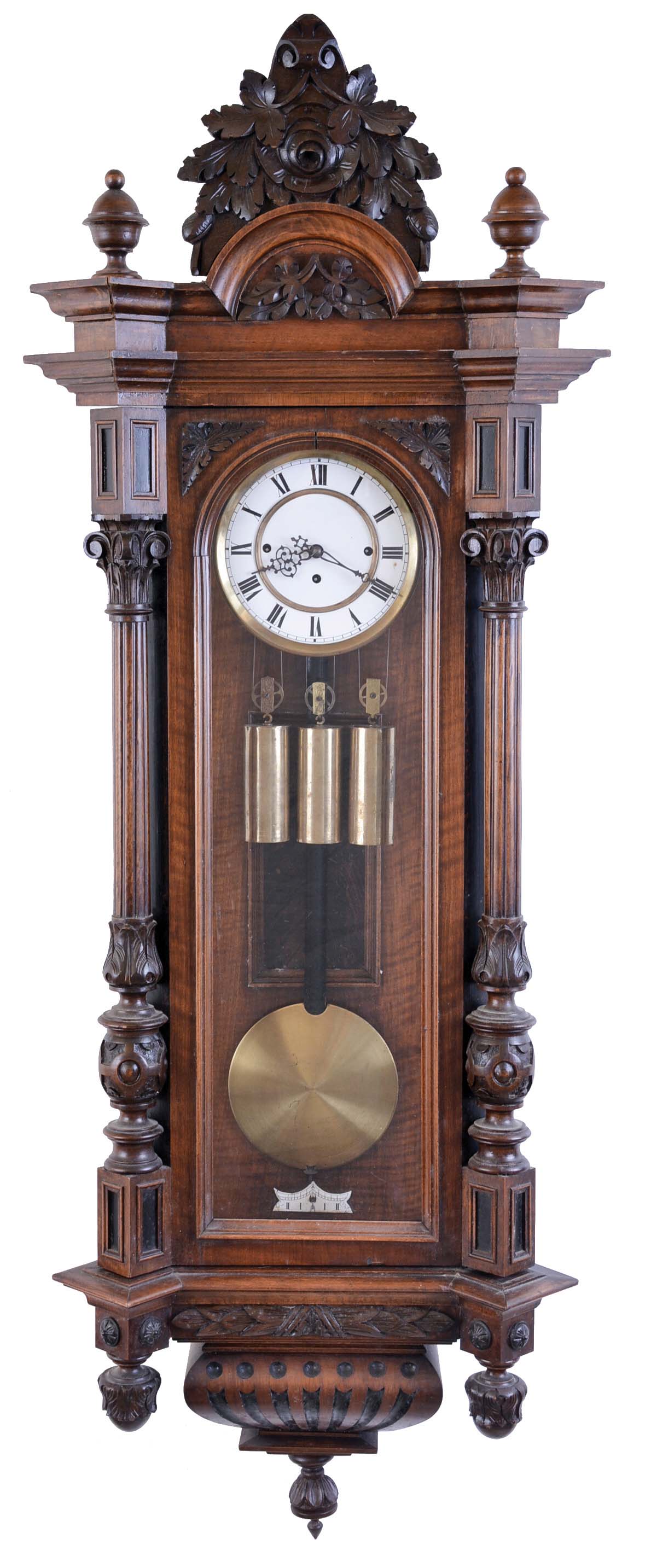 Austria, a large grand sonnerie hanging regulator, walnut case with carved and turned ornament, large base and cornice moldings, and foliate carved crest, Roman numeral two piece white enamel dial, 8 day, weight driven, three train quarter striking movement, brass pendulum with wooden rod, and three brass weights — Antique Clocks Price Guide