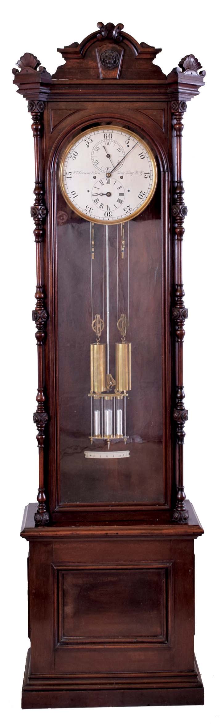 Wm. Lawrence &amp; Sons, Sing Sing, NY, standing astronomical regulator, 8 day, time and strike, two brass weight driven movement with three jar mercury pendulum and pinwheel escapement in a walnut case with carved top and full slender columns flanking door over base with recessed panel and silvered metal dial with maker's signature, backplate dated 1877 — Antique Clocks Price Guide