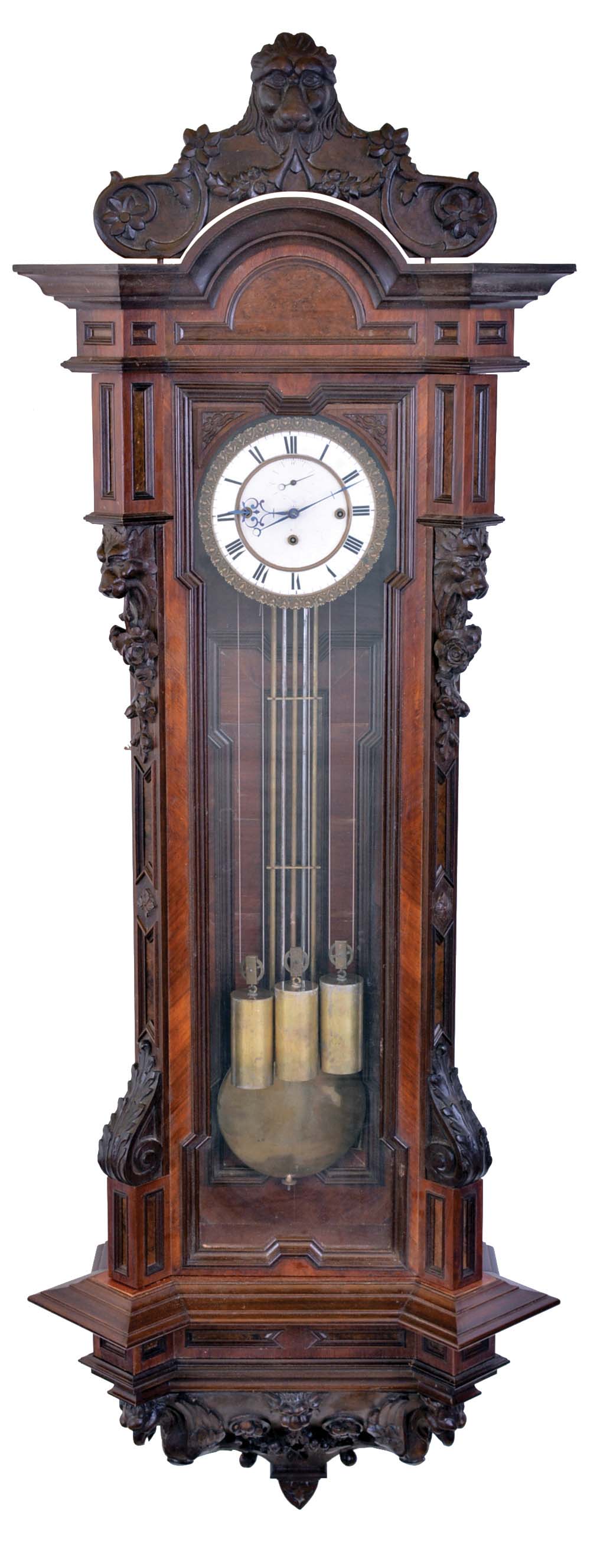 Vienna regulator, large, angular case with wanut veneers and framed burl walnut veneer panels, carved crest and base, cast bezel with two piece Roman numeral white enamel dial, blued steel hands, three train, quarter striking movement, with brass and steel gridiron pendulum and brass weights — Antique Clocks Price Guide