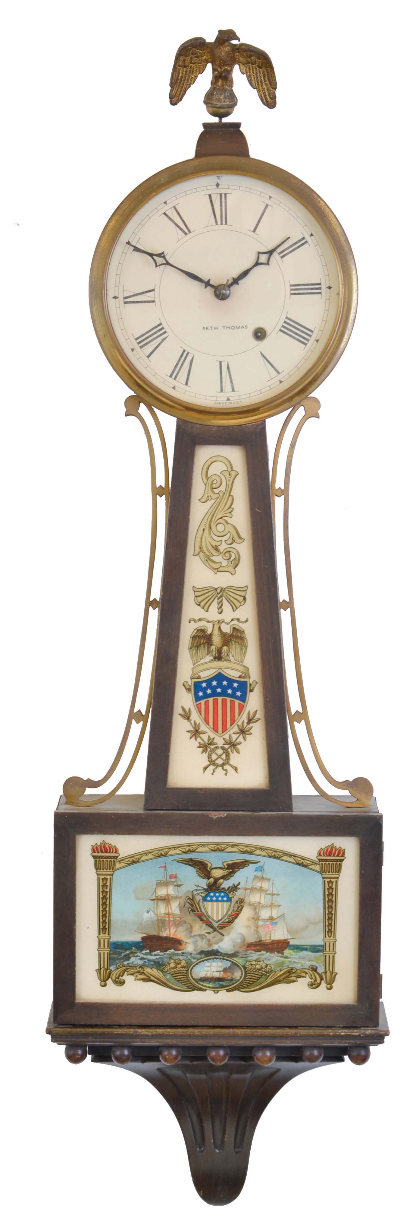 Seth Thomas Clock Co., Thomaston, Conn., "Banjo No. 1" hanging clock with a spring driven 8 day timepiece movement in a mahogany case with polished brass side ornaments. — Antique Clocks Price Guide