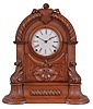 American Clock Co., 3 Cortlandt St. N.Y., shelf clock, walnut case with arch top, decorated with bold turned and carved elements, Roman numeral white enamel dial, blued steel hands, and 8 day time and strike Seth Thomas movement with lyre plates