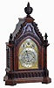 Frederick James Lockwood, West Norwood, London, large bracket clock in the Gothic style, carved oak case with buttress corners supporting turned columns, the molded base with lancet arch blind fret, lancet arch door below a carved lintel, the tympanum with applied, modified foil and hawksbill molding, all topped with foliate carving and decorative finials, case sides with pierced wooden frets, Arabic numeral silvered dial with gilt spandrels, with subsidiary dials for selecting chime tune, mode and regulation, blued steel hands, and substantial, 8 day, 3 train fusee movement, sounding the quarters on four or eight bells and counting the hours on a large gong, the back plate also signed, c1845