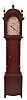 Silas Hoadley, Plymouth, Conn., tall clock, 30 hour, time and strike with calendar, weight driven, wooden works movement in a dark stained pine case with columns flanking trunk door and three brass finials. The wooden painted dial and pewter hands.
