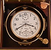 Hamilton Watch Co., Lancaster, Penn., model 21 marine Chronometer, 14 jewel key wind and set, straight line damascened nickel plate movement, with spring detent escapement and Chronometer balance with helical hairspring, Arabic numeral metal dial with wind indicator, engraved "U.S. Maritime Commission", black painted steel spade and poker hands, contained in a gimbaled mahogany box with brass hardware, the front with U.S. Maritime commission plaque, and the inside of the box top with instruction plate, serial #2E10626, c1945