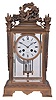 France, for Shreve, Crump & Low, Boston, crystal regulator with gilt bronze case, the base with foliate ornamented molding, the four corners mounted with torches, and the top surmounted by a trophy incorporating a bow, arrows, quiver, and torch, all encircled by a laurel wreath, Roman numeral white enamel dial, blued steel Breguet style hands, and 8 day, time and strike pendule de Paris movement with 2 vial mercury pendulum