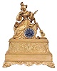 France, a Louis Philippe gilt bronze mantel clock, the case with bright and matte surfaces and decorated with Grecian ornament, surmounted by a figure of a seated young woman with fashionable hairstyle, comb, and dress, admiring her reflection in a hand mirror, and with a parlor guitar to her left, signed, Roman numeral silvered dial, blued steel Breguet style hands, 8 day time and strike pendule de Paris movement with silk thread suspension, signed "Pons"
