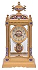 France, crystal regulator, the gilt bronze and champleve enamel decorated architectural case with stepped, molded base, the corners with columns supporting a corbelled cornice, and cushion top surmounted by an urn, silvered concave dial with champleve center, and 8 day, time and strike pendule de Paris movement, brass pendulum also with champleve decoration