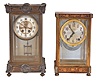 Clocks- 2 (Two): (1) Seth Thomas Clock Co., Thomaston, Conn., "Empire No. 4", 8 day, time and strike spring brass movement crystal regulator, c1904 (2) William L. Gilbert Clock Co., Winsted, Conn., "Falmouth", 8 day, time and strike spring brass movement crystal regulator, c1913