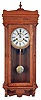 Clocks- 4 (Four): Clocks- 4 (Four): (1) Unmarked Baltimore style banjo reproduction wall clock with a spring driven movement in a wood case. c2000. (2) Unmarked reproduction of the Waterbury "Leeds" wall hanging clock with a spring driven 31 day time and strike movement in an oak case, c1980.. (3) Unmarked Baroque style wall hanging clock with a spring driven 31 day time and strike movement in an oak case c1980 (4) This clock is the same as number three (3) with the exception of the satin brass style dial, c1980.