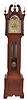 New Haven Clock Co., New Haven, Conn., "Sherbrooke" variant tall clock, 8 day, time, strike and Westminster chime on gongs, three brass weight driven ladder chain movement with Wilcox patent signed subsidiary movement to drive chimes in a mahogany case with broken arch top, four full carved columns on hood, beveled glass trunk door, bracket base and feet. The silvered brass dial has moon.