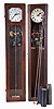 The Synchronome Co., Ltd., England, master clock, quarter sawn oak case, Arabic numeral metal dial, and pendulum with cylindrical ball, receiving impulse every thirty seconds from a falling gravity arm, together with another Synchronome master clock with mahogany case, Roman numeral silvered dial, and also with correct pendulum, plus a third pendulum