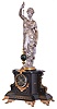 France, a monumental figural mantel clock with conical pendulum, the black slate case with gilt, incised line decoration and mounted with cast foliate ornament, the top with silvered, standing female figure in flowing garb, with right arm held aloft and supporting the pendulum, the base signed "S. Fouquet", black slate dial with gilt Roman numerals, gilt spade hands, and 8 day time and strike pendule de Paris movement