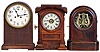 Clocks- 3 (Three): (1) Seth Thomas Clock Co., Thomaston, Conn., "Tudor No. 1" shelf clock with an 8 day spring driven time and strike lyre movement in a rosewood case, c1870 (2) Seth Thomas Clock Co., Thomaston, Conn., "Arch Top" model shelf clock with an 8 day spring driven time, strike and alarm movement in a walnut case, c1875. (3) Waterbury Clock Co., Waterbury, Conn., "Birmingham" model shelf clock with as 8 day spring driven time and half hour strike movement in a mahogany case, c1920.